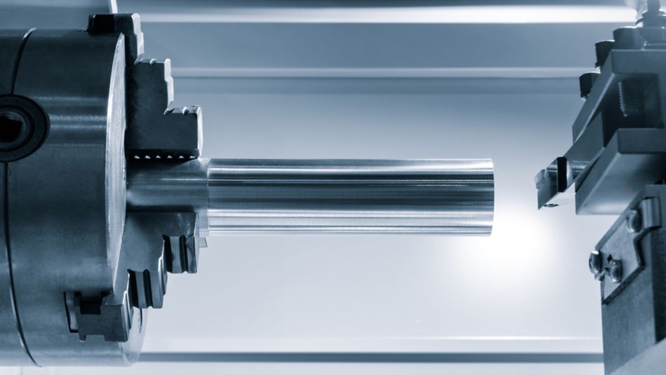 A metal rod is being cut by a machine