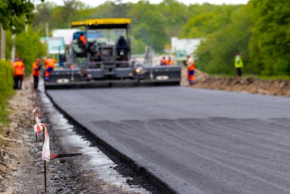 Asphalt paver laying new road