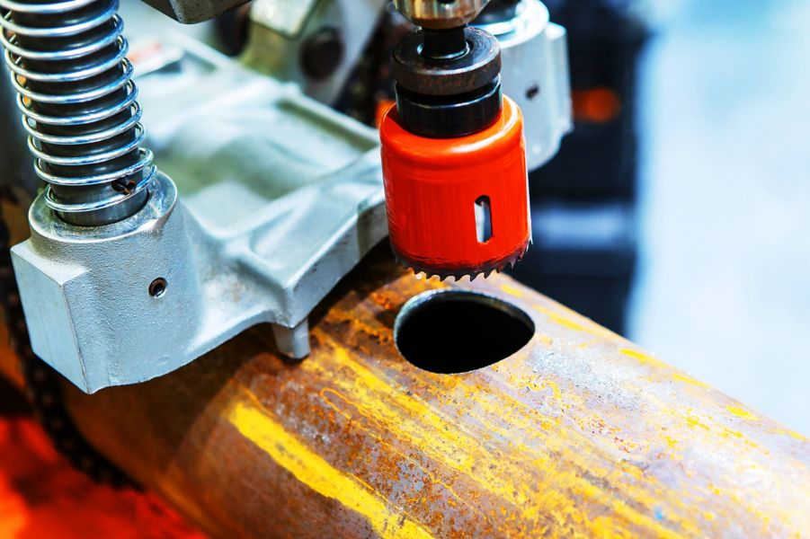 Equipment for cutting holes in metal. The iron pipe is sawn with a special tool. Close-up