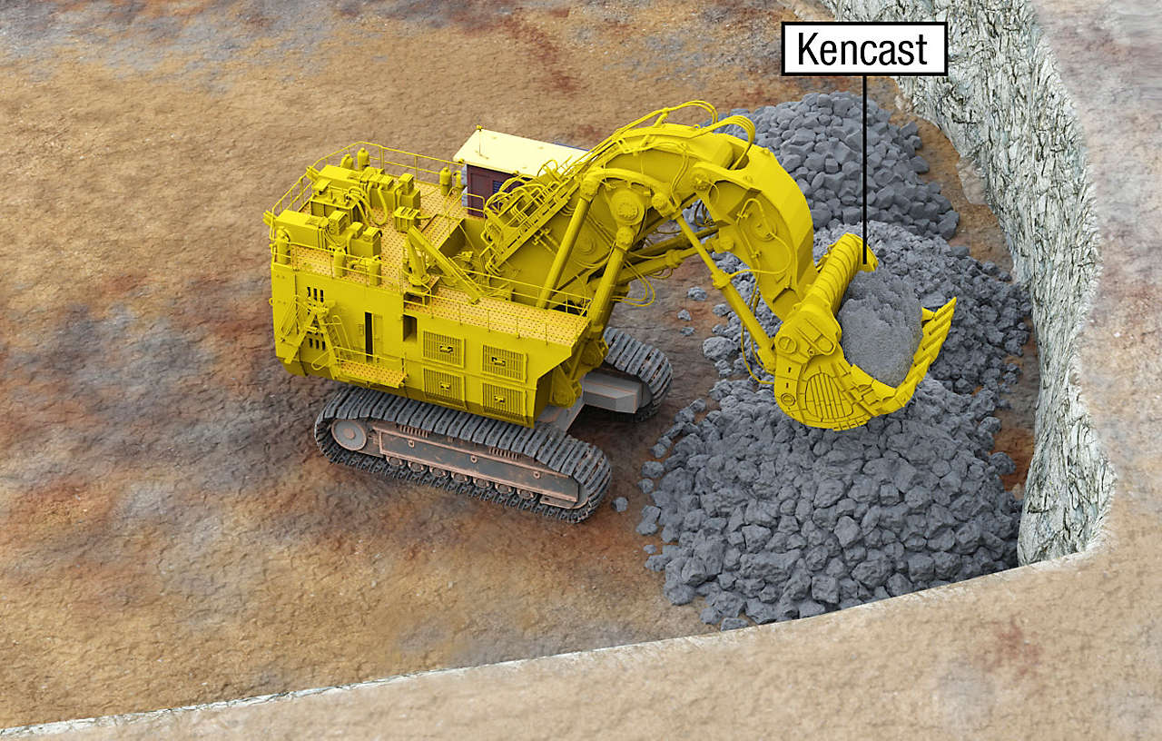 Construction excavator with Kencast label holding rocks
