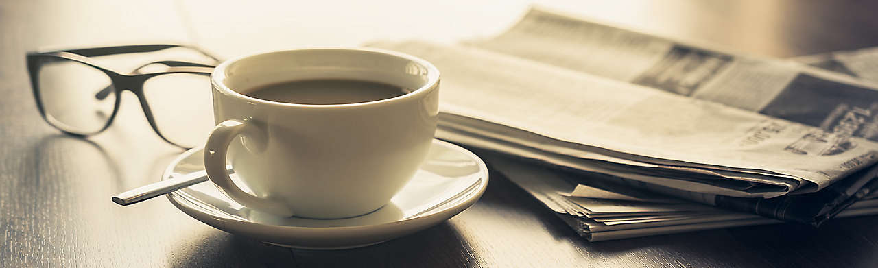 Coffee, Newspaper, and Reading Glasses Banner