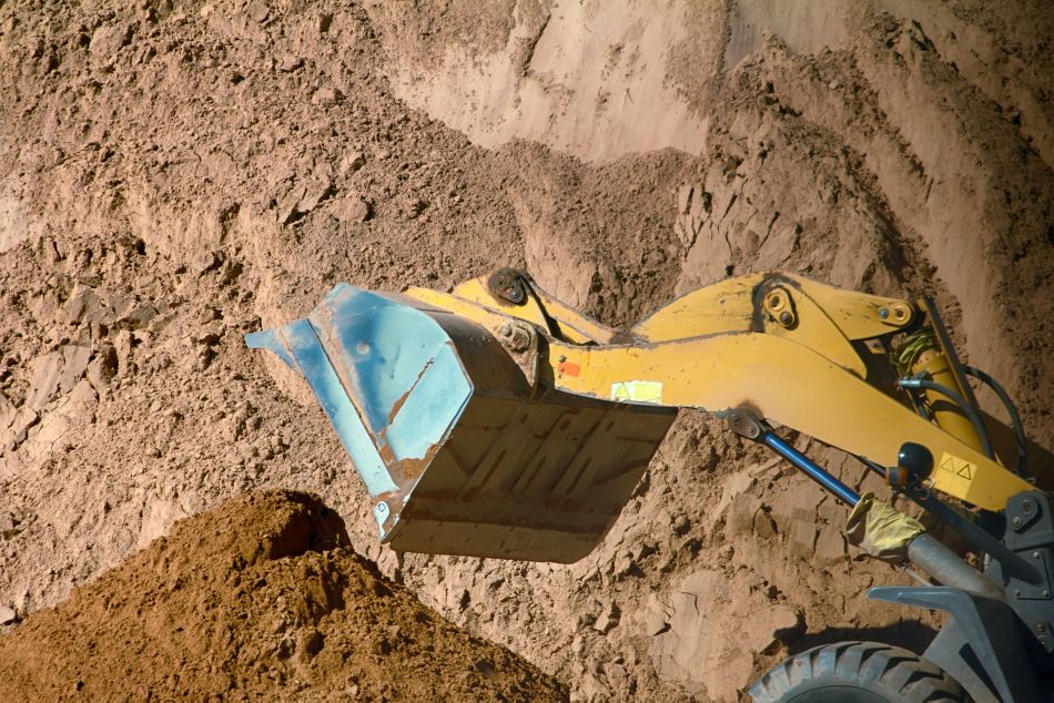 Construction excavator performing earthwork operation