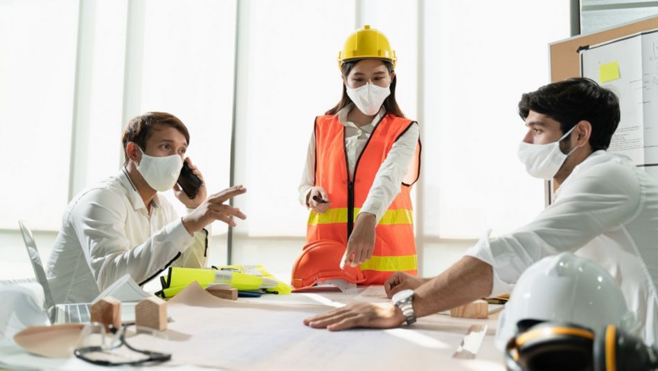 Group construction worker are meeting and brainstorm together at the workplace to discuss for new project during covid19 pandemic, Architect engineer teamwork wearing face mask while discuss together.