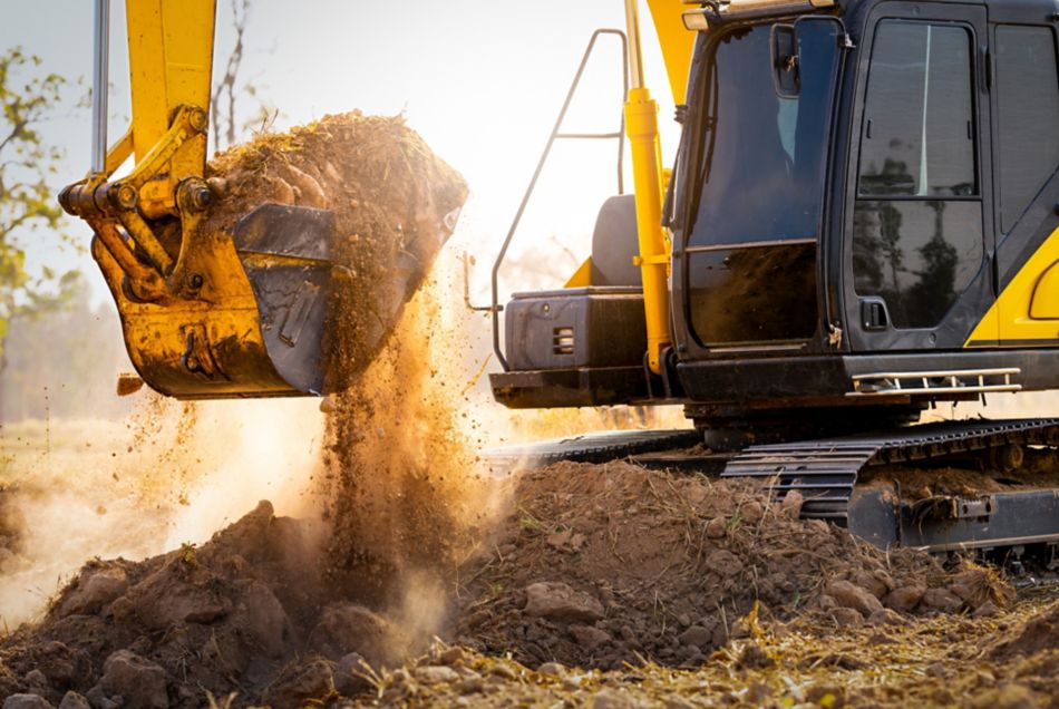 Close-up of excavator at construction site. Backhoe digging soil for earthwork and construction business. Excavating machine at work. Heavy machinery for earth moving and construction site development