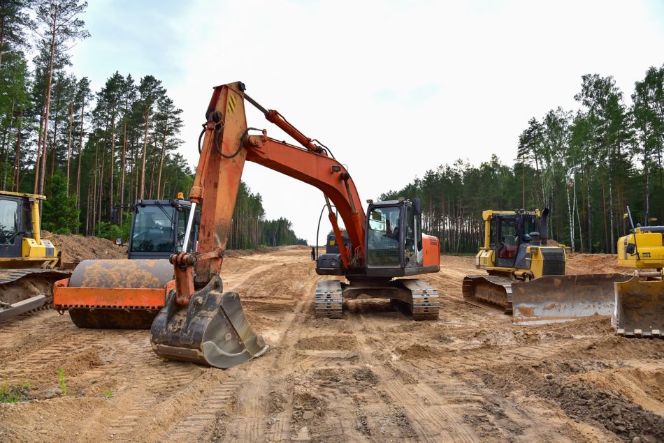 Bulldozer, Excavator and Soil compactor on road work. Earth-moving heavy equipment and Construction machinery during land clearing, grading, pool excavation, utility trenching and digging