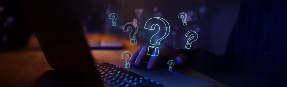 Questions marks with person typing on a laptop