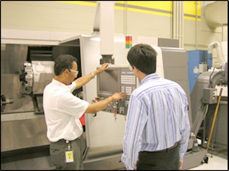 Two Kennametal Employees working on CNC Machine