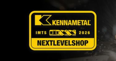 Kennametal solid carbide drill spraying coolant with Kennametal IMTS 2026 "Next Level Shop" badge