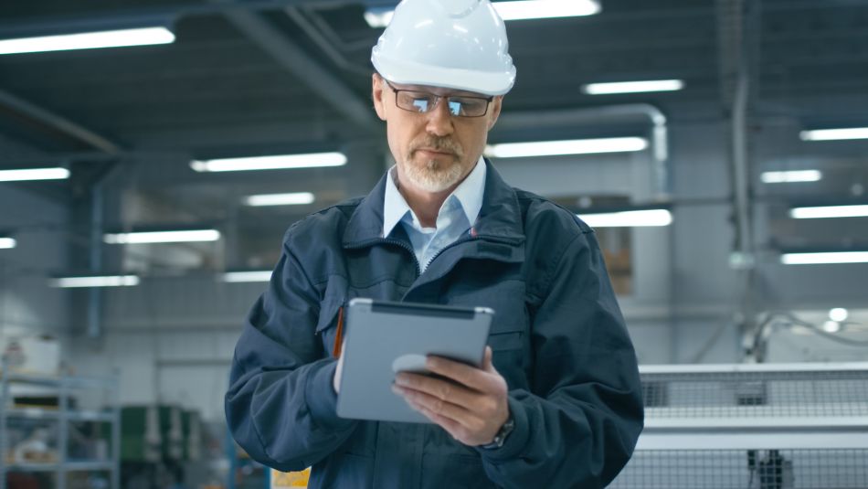 Man in Hardhat Using a Tablet