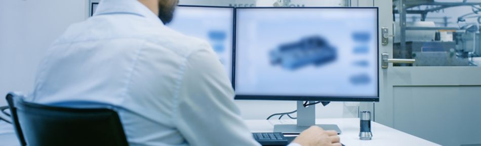 Man Working on CAD Program at a Desk Banner