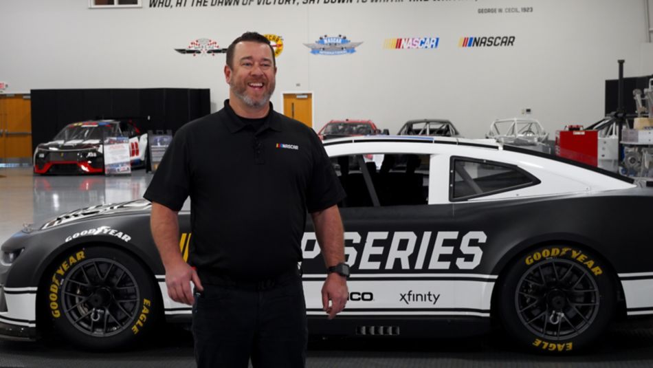 Hank Fowler, NASCAR, in front of a race car