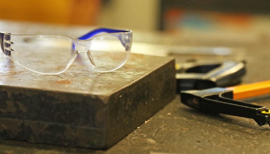 Safety goggles in the industrial technology workshop  with tools.