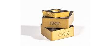 Three KCP25C turning inserts stacked on top of one another