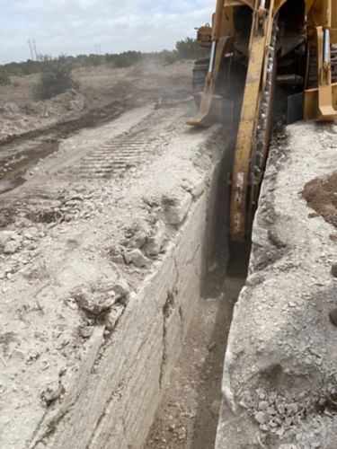 Trencher Excavating Solid Rock at Five Foot Cut Depth