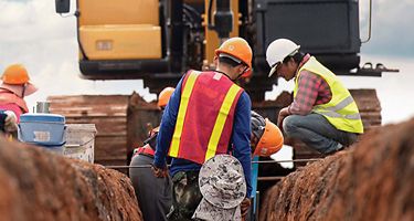 Construction workers working on a trench