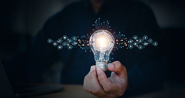 Person holding lightbulb